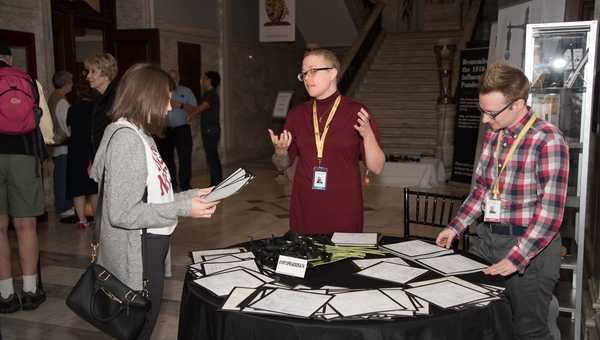 Three volunteers gathered around a table and talking